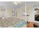 Bright main bedroom with a king bed, a dresser with a television and balcony access at 141 Cayman Loop, Pawleys Island, SC 29585