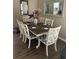Dining room with a wood table, white chairs, and a mirror, creating an elegant and inviting space at 1432 Seahouse Ct., Surfside Beach, SC 29575