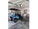 Spacious garage with a golf cart, utility bench and lighting fixtures for convenience at 1432 Seahouse Ct., Surfside Beach, SC 29575