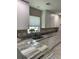 Bright kitchen featuring granite countertops, stainless steel sink, and modern white cabinets at 1432 Seahouse Ct., Surfside Beach, SC 29575