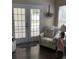Cozy sitting area featuring a floral armchair, French doors to patio, and a sunlit window at 1432 Seahouse Ct., Surfside Beach, SC 29575