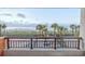 Balcony offers a stunning view of the beach and palm trees at 1501 Ocean Blvd. S # 242, Myrtle Beach, SC 29577