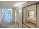 Hallway view featuring unit doorway and a glimpse into a bedroom with a bed and partial kitchen at 1501 Ocean Blvd. S # 242, Myrtle Beach, SC 29577