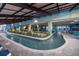 Indoor lazy river with lush planters and seating areas for a tranquil experience at 1501 Ocean Blvd. S # 242, Myrtle Beach, SC 29577