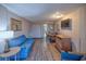 Inviting living room with blue sofa, dining space, and entertainment area at 1501 Ocean Blvd. S # 242, Myrtle Beach, SC 29577