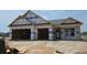 New construction home featuring a two-car garage and classic architectural design still under construction at 1531 Breakwater Dr., Little River, SC 29566