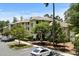 Well-maintained condo building with manicured landscaping, private balconies, and ample parking on a sunny day at 1551 Spinnaker Dr. # 5312, North Myrtle Beach, SC 29582