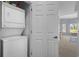 Convenient stacked laundry unit with a view into the adjacent bedroom at 1551 Spinnaker Dr. # 5312, North Myrtle Beach, SC 29582