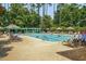 Community pool with ample seating and lush landscaping creating a resort-like atmosphere for relaxation at 1551 Spinnaker Dr. # 5312, North Myrtle Beach, SC 29582