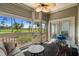 Relaxing screened-in porch with golf course views, cozy seating, and a ceiling fan for comfortable outdoor living at 1551 Spinnaker Dr. # 5312, North Myrtle Beach, SC 29582