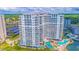 Stunning aerial view of the white SeaWatch Resort condo building, pools, landscaping and parking at 161 Sea Watch Dr. # 601, Myrtle Beach, SC 29572