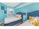 Bright bedroom featuring two twin beds with blue headboards and sunflower-themed pillows at 161 Sea Watch Dr. # 601, Myrtle Beach, SC 29572