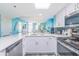 Open kitchen with white cabinetry and stainless steel appliances flows into the living area at 161 Sea Watch Dr. # 601, Myrtle Beach, SC 29572