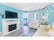 Living room featuring fireplace, TV, leather couches and ocean view from balcony at 161 Sea Watch Dr. # 601, Myrtle Beach, SC 29572
