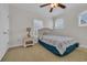 Well lit bedroom with carpet and a bed next to a white nightstand with a lamp at 1619 Eastover Ln., North Myrtle Beach, SC 29582