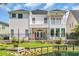 Two-story home featuring dual balconies, a covered patio, fenced backyard and waterfront views at 1619 Eastover Ln., North Myrtle Beach, SC 29582