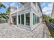 Exterior showcasing the sunroom, covered patio, and paver patio, blending indoor and outdoor living spaces at 1619 Eastover Ln., North Myrtle Beach, SC 29582