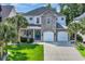 Beautiful two-story home with a stone facade and well-maintained landscaping and two-car garage at 1619 Eastover Ln., North Myrtle Beach, SC 29582