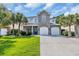 Charming home with a combination of stone and siding, complemented by lush palm trees and a two car garage at 1619 Eastover Ln., North Myrtle Beach, SC 29582