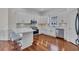 Modern kitchen featuring white cabinets, stainless steel appliances, and a breakfast bar with seating at 1619 Eastover Ln., North Myrtle Beach, SC 29582