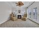 Living room with carpet, a fireplace, seating, and natural light coming from large glass doors at 1619 Eastover Ln., North Myrtle Beach, SC 29582
