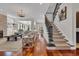 Open-concept living room with hardwood floors, fireplace, staircase, and plenty of natural light at 1619 Eastover Ln., North Myrtle Beach, SC 29582