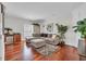 Cozy living room with hardwood floors, wet bar, comfortable sectional sofa, and bright natural light at 1619 Eastover Ln., North Myrtle Beach, SC 29582