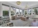 Light-filled sun room with large windows and comfortable seating arrangements at 1619 Eastover Ln., North Myrtle Beach, SC 29582