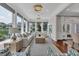 Bright sun room featuring large windows, elegant chandeliers, and hardwood floors at 1619 Eastover Ln., North Myrtle Beach, SC 29582