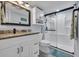 Bathroom with modern vanity, mirror, and tiled walk-in shower at 1625 S Ocean Blvd. # 211, North Myrtle Beach, SC 29582