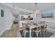 Dining area flows into a bright, modern kitchen featuring white cabinets and wood-look floors at 1625 S Ocean Blvd. # 211, North Myrtle Beach, SC 29582