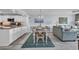 Coastal-themed dining area open to kitchen and living spaces features a modern light fixture at 1625 S Ocean Blvd. # 211, North Myrtle Beach, SC 29582
