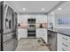 Modern kitchen with stainless appliances, white cabinetry, and granite countertops at 1625 S Ocean Blvd. # 211, North Myrtle Beach, SC 29582