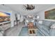 Open-concept living area with wood-look flooring, coastal decor, and an adjacent kitchen at 1625 S Ocean Blvd. # 211, North Myrtle Beach, SC 29582
