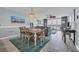 Open-concept living area with wood-look floors, dining table, and balcony access offering stunning water views at 1625 S Ocean Blvd. # 211, North Myrtle Beach, SC 29582