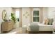 Bright bedroom featuring stylish decor, a queen-sized bed, a dresser, and beach themed decorations at 1740 Hunting Harris Ct # 9, Ocean Isle Beach, NC 28469