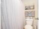 Neat bathroom featuring a toilet, shower with curtain, and decorative wall art at 1900 Duffy St. # L4, North Myrtle Beach, SC 29582