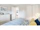 Well-lit bedroom featuring a beach-themed art piece, white dresser, and view to the next room at 1900 Duffy St. # L4, North Myrtle Beach, SC 29582