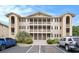 Three-story condo complex showcasing private balconies and well-manicured landscaping at 1900 Duffy St. # L4, North Myrtle Beach, SC 29582