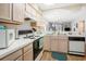 Well-lit kitchen with white countertops, wood cabinets, and views into adjacent living space at 1900 Duffy St. # L4, North Myrtle Beach, SC 29582
