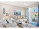 Cozy living room with comfortable seating, a painting, and a sliding door to a balcony at 1900 Duffy St. # L4, North Myrtle Beach, SC 29582