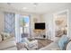 Comfortable living room with balcony access and views into the bedroom at 1900 Duffy St. # L4, North Myrtle Beach, SC 29582