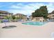 Outdoor swimming pool and jacuzzi with blue lounge chairs and meticulously maintained grounds and landscaping at 1900 Duffy St. # L4, North Myrtle Beach, SC 29582