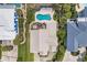 Aerial view of a beautiful home with an in-ground pool, deck, and lush landscaping at 191 Grackle Ln., Pawleys Island, SC 29585