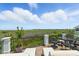 Outdoor balcony features chairs and lounge furniture with scenic water view in the distance at 191 Grackle Ln., Pawleys Island, SC 29585