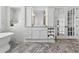 Bathroom featuring marble flooring, double vanity with sink and white cabinets, and white doors at 191 Grackle Ln., Pawleys Island, SC 29585