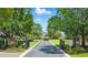 View of home from the entry gate through a long driveway lined with mature trees at 191 Grackle Ln., Pawleys Island, SC 29585