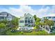Rear exterior view of a two-story home featuring a backyard pool, deck, and lush landscaping at 191 Grackle Ln., Pawleys Island, SC 29585