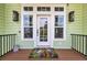 Inviting front door entrance with sidelights, decorative lights and a charming butterfly-themed doormat at 191 Grackle Ln., Pawleys Island, SC 29585
