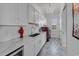 Bright laundry room with marble countertops, chandelier, white cabinets, and tiling at 191 Grackle Ln., Pawleys Island, SC 29585